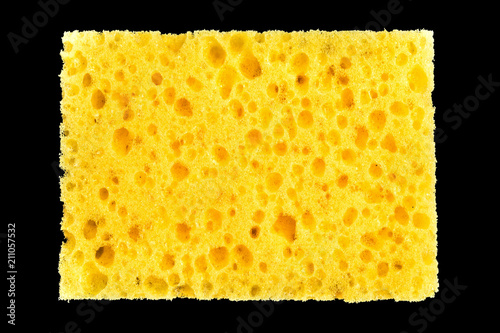 Canvas Print new yellow sponge for washing dishes on black background, abstract background