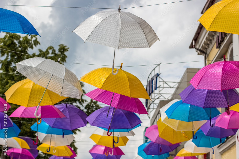 colorful white yellow pink purple and blue umbrellas decoration on urban street environment space outdoor concept