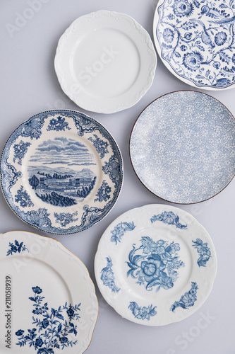Vintage painted plates dishes several many group set white dishes on white background.