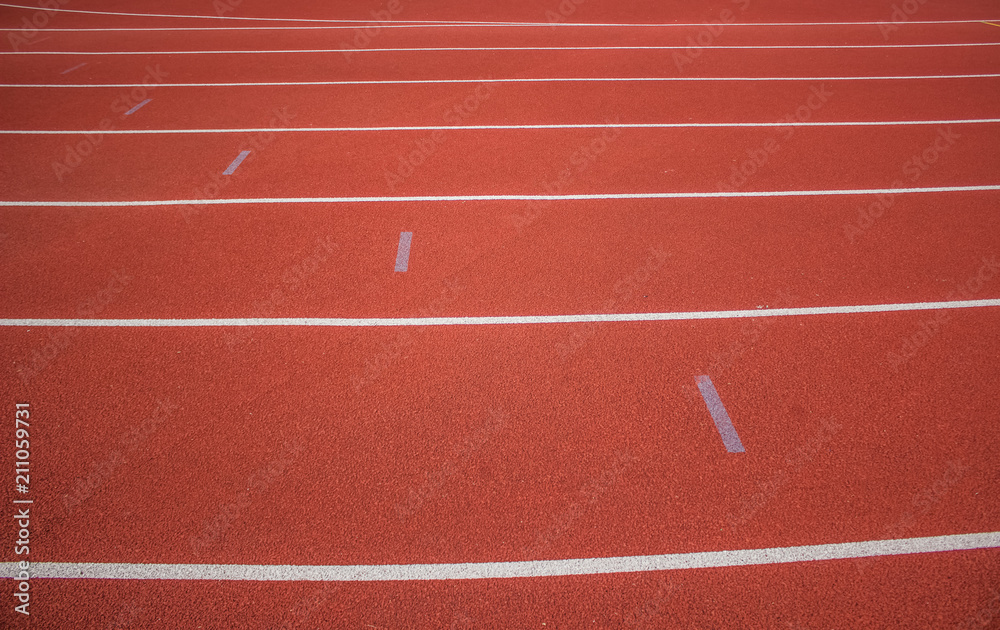 soft focus empty red running road track background texture concept with marking of white line and space for copy or text