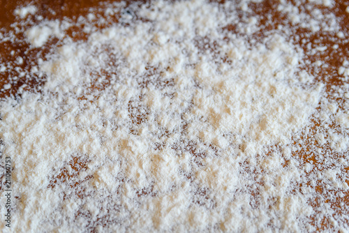 Top side view on white flour on rustic wooden table background, closeup of healthy cooking copyspace surface at home, restaurant, fabric plant © gorosi