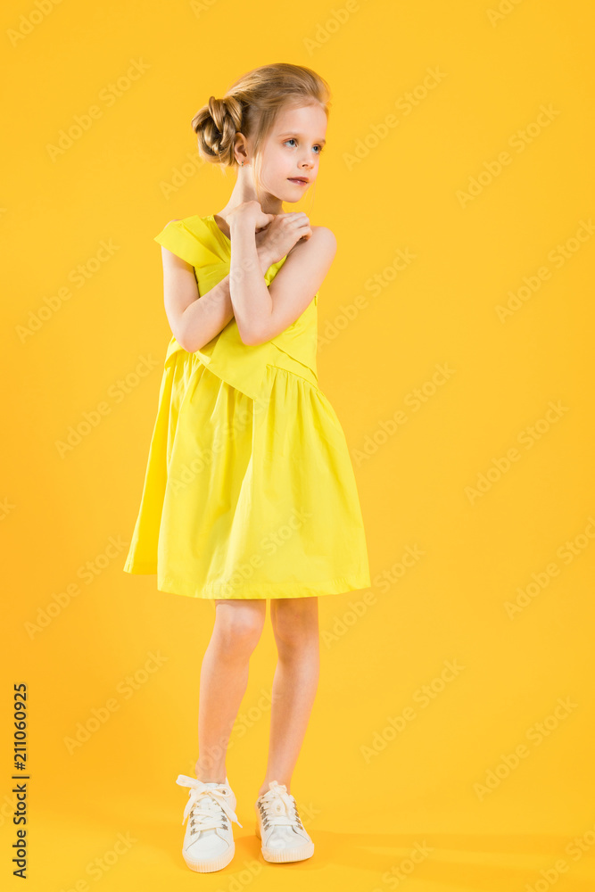 The blonde girl put her hands to her neck and looks away. The blonde girl put her hands to her neck and looks away.