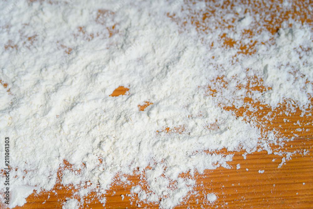 Fototapeta premium Top side view on white flour on rustic wooden table background, closeup of healthy cooking copyspace surface at home, restaurant, fabric plant