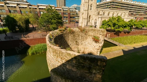 Telephoto shot featuring a Roman Fort and the St Giles Cripplegate Church in the Barbican area of the London Wall, England, UK photo