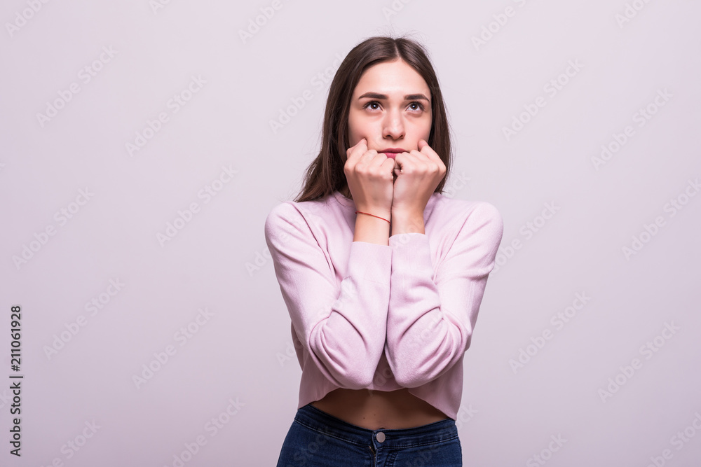 Pretty woman covering their mouths and looking at the camera over white background Pretty woman covering their mouths and looking at the camera over white background