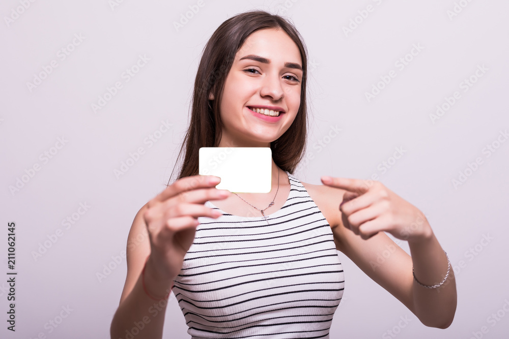 Happy smiling woman showing blank credit card, on white background Happy smiling woman showing blank credit card, on white background