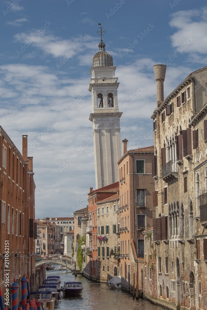 View of a typical Venice canal with a leaning bell tower