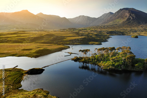 Twelve Pines Island, standing on a gorgeous background formed by the sharp peaks of a mountain range called Twelve Bens, County Galway, Ireland photo