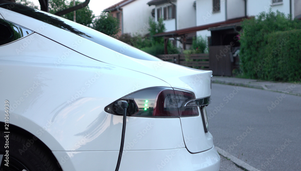 CLOSE UP: Tesla electric autonomous car filling batteries at home station