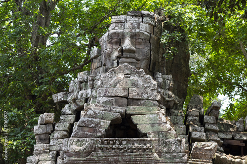 Ancient stone ruin of Banteay Kdei temple, Angkor Wat, Cambodia. Ancient temple tower with face in forest