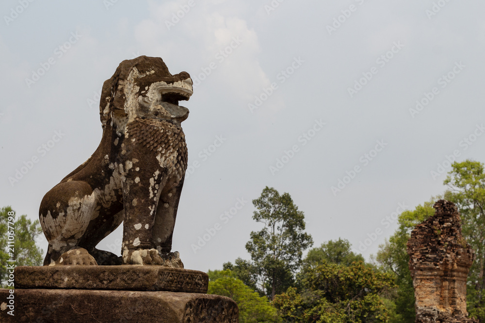 Mossy stone lion statue, Angkor Wat complex, Cambodia. Ancient temple in Siem Reap.