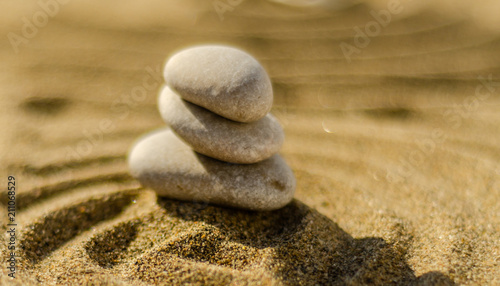 Canvas Print zen meditation stone in sand, concept for purity harmony and spirituality, spa w