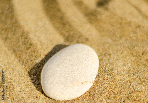 zen meditation stone in sand, concept for purity harmony and spirituality, spa wellness and yoga background