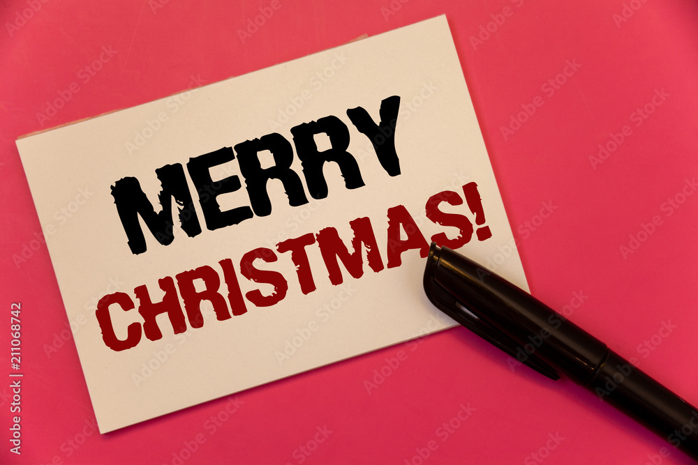 Text sign showing Merry Christmas Motivational Call. Conceptual photo Holiday Season Celebration December Text two Words notes written note paper black pen message pink background. Text sign showing Merry Christmas Motivational Call. Conceptual photo Holiday Season Celebration December Text two Words notes written note paper black pen message pink background.