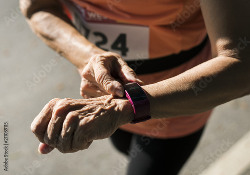 Senior runner using a fitness tracker