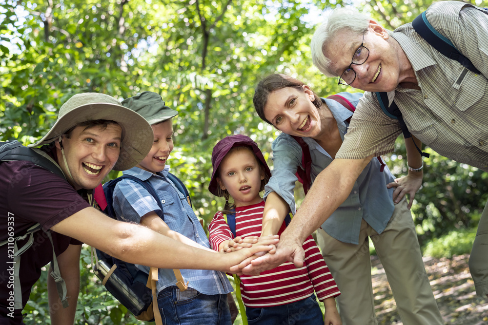 Fototapeta premium Family stacking hands as a team