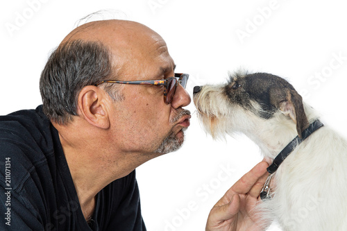 Man Giving Kiss to Shaggy Terrier Crossbreed Dog