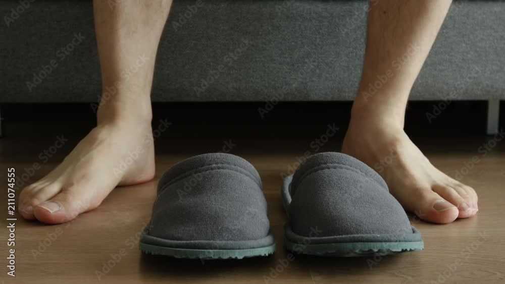 Young adult man slow slips a slippers and go out Young adult man slow slips a slippers and go out