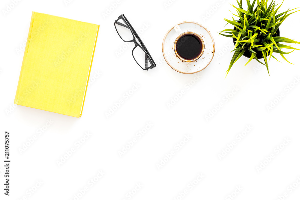 Intellectual entertainment concept. Books with empty cover near glasses, coffe, plant on white desk top view space for text Intellectual entertainment concept. Books with empty cover near glasses, coffe, plant on white desk top view space for text