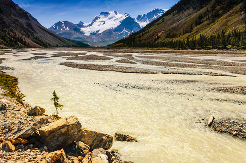 Yellow river between the mountains in Banff National Park