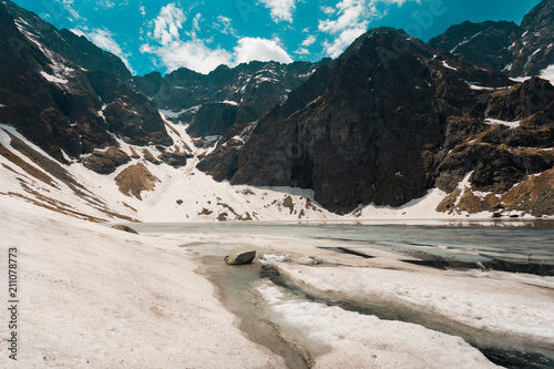 Fototapeta Naklejka Na Ścianę i Meble -  Icy lake between mountains