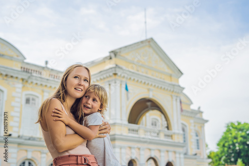 Mom and son on background of Old Town Hall in George Town in Penang, Malaysia. The foundation stone was laid in 1879 photo