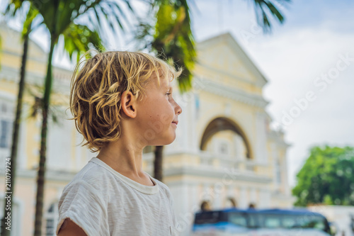 Boy on background of Old Town Hall in George Town in Penang, Malaysia. The foundation stone was laid in 1879 photo