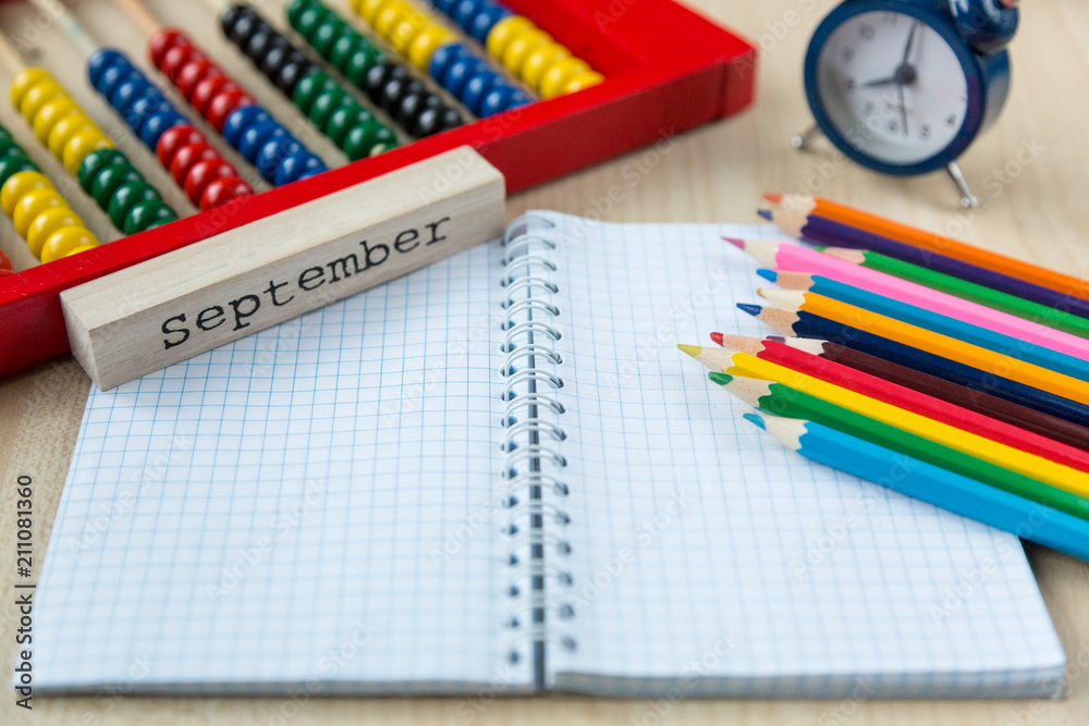 colorful abacus , pencils, clock, chalkboard on the wooden background. Education, back to school concept colorful abacus , pencils, clock, chalkboard on the wooden background. Education, back to school concept