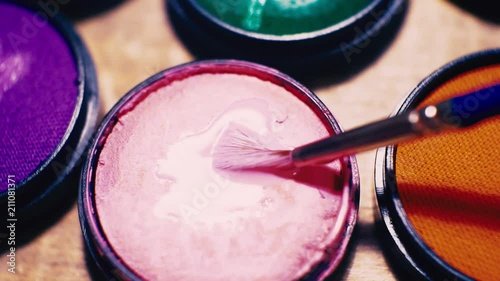 jars of make-up of different colors close-up. photo