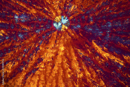 Abstract micrograph of orange and blue lysine crystals. photo