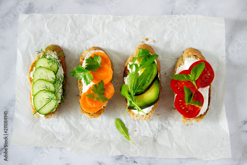 Various vegetarian sandwiches with useful bread, vegetables and herbs. photo