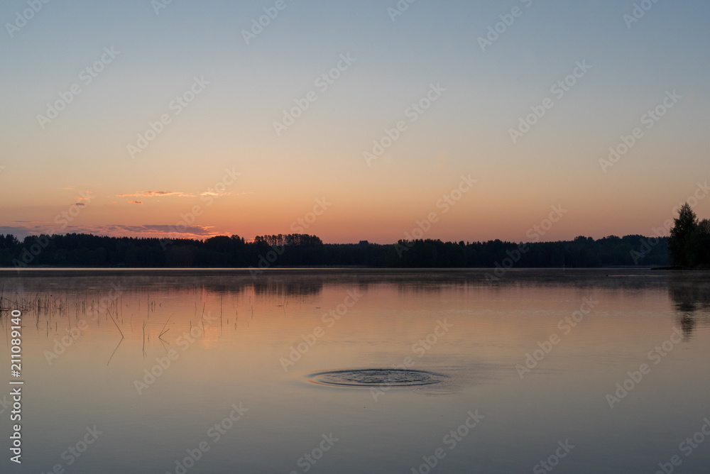 Sunrise at early morning, calm lake and water movement Sunrise at early morning, calm lake and water movement