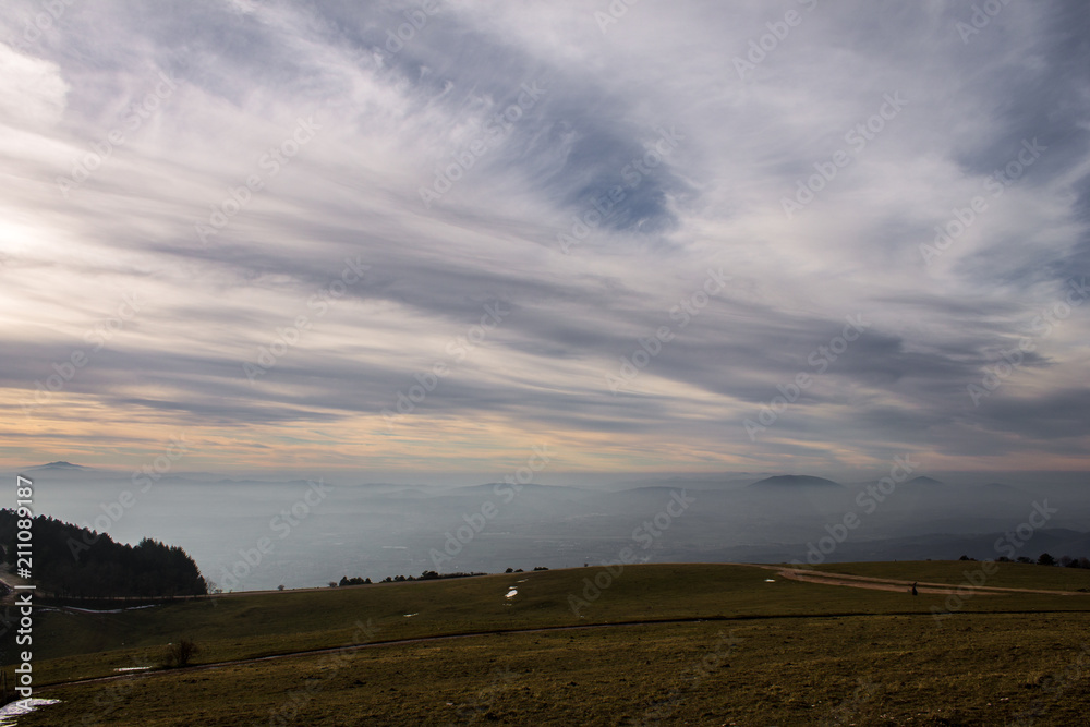 Subasio Mt. (Umbria, Italy), with sky covered by clouds and warm sunset colors