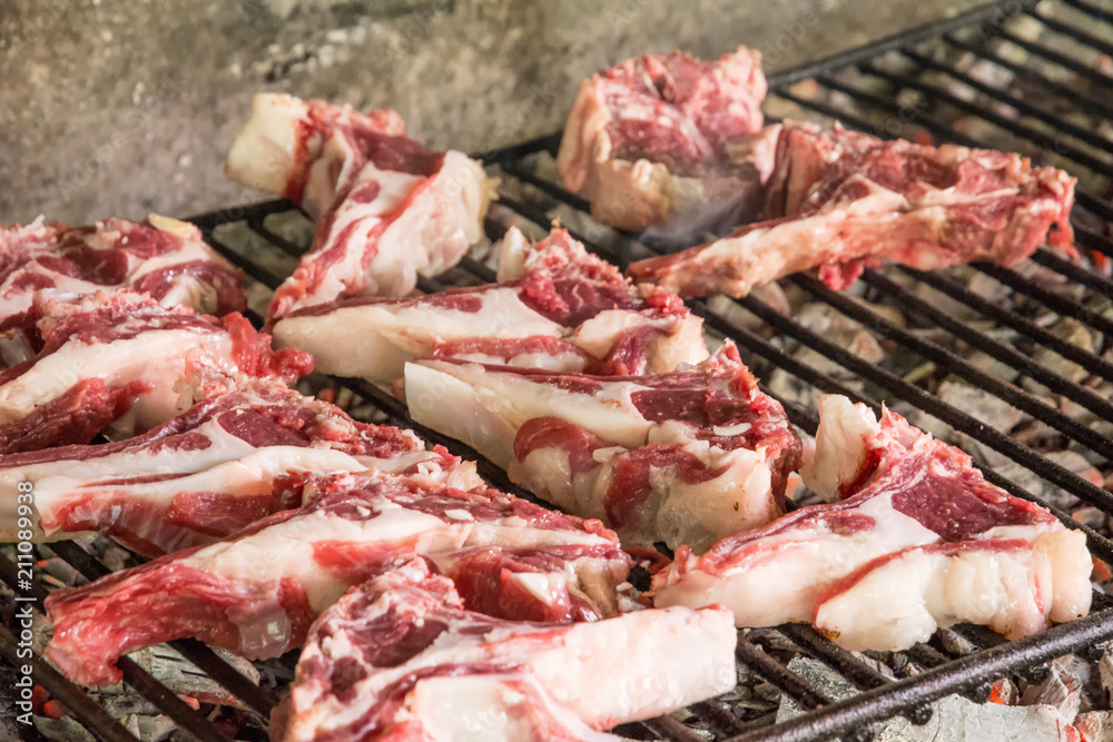 grilled goat chops. Roast meat on a barbecue Typical brick barbecue in Sardinia, Italy. Selective focus