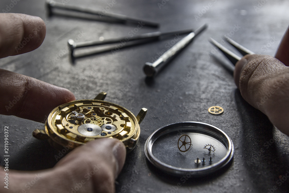 Watchmaker is repairing the mechanical watches in his workshop