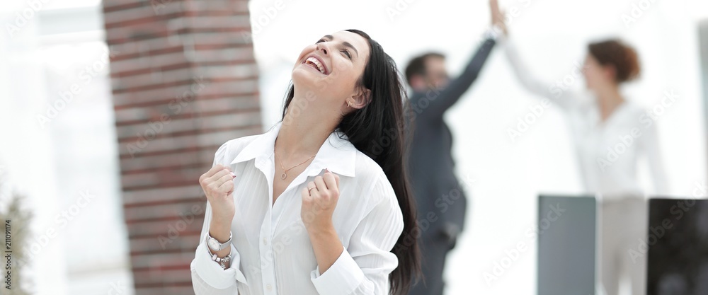 Fototapeta premium happy young business woman on a blurred office background.