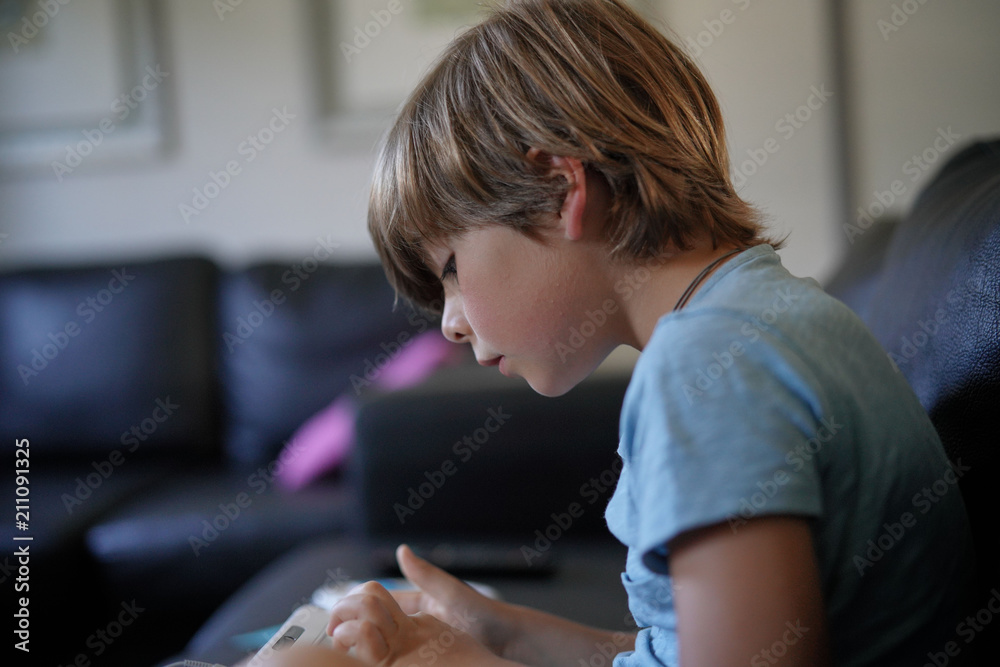 Young boy playing with video game console Young boy playing with video game console