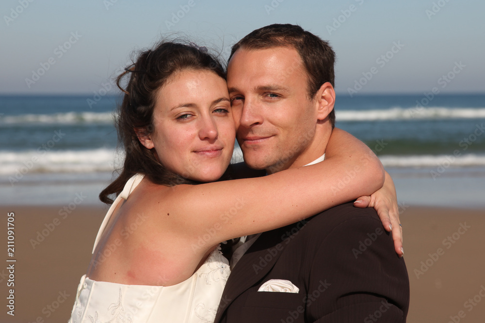 Very happy portrait couple enjoy each other on the beach of blue sea in love Very happy portrait couple enjoy each other on the beach of blue sea in love