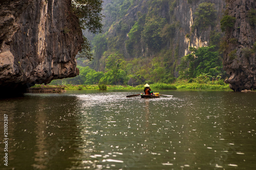 Touristic boat ride in Hao Lu in Ninh Binh city, Vietnam.It is a famous national park with its rivers and the caves. © yavuzsariyildiz