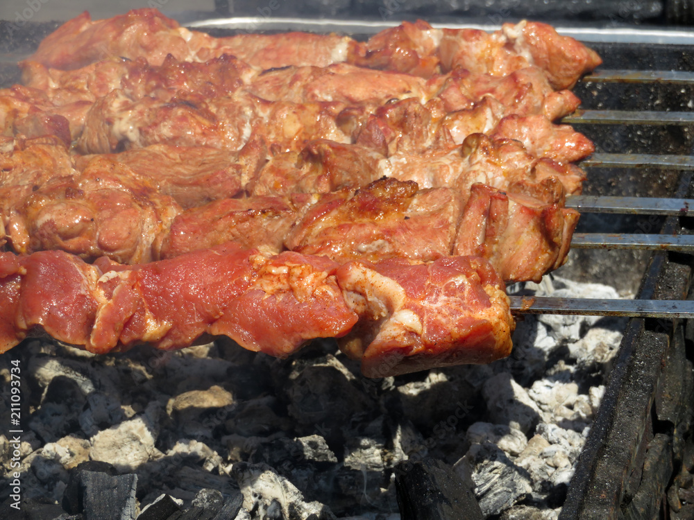Kebabs frying on an open fire, shashlik on charcoal. Meat cooking on the grill