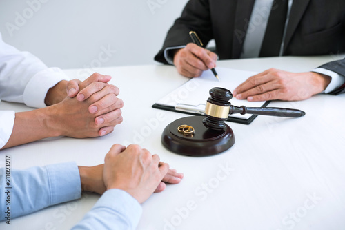 Agreement prepared by lawyer signing decree of divorce (dissolution or cancellation) of marriage, husband and wife during divorce process with male lawyer or counselor and signing of divorce contract