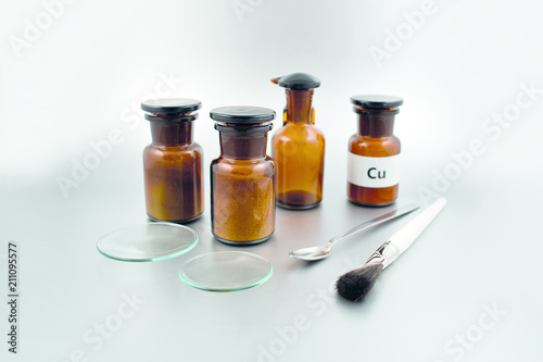 Laboratory accessories stock images. Vials on a silver background. Brown glass containers. Brown chemical glass. Glass Pasteur Pipettes