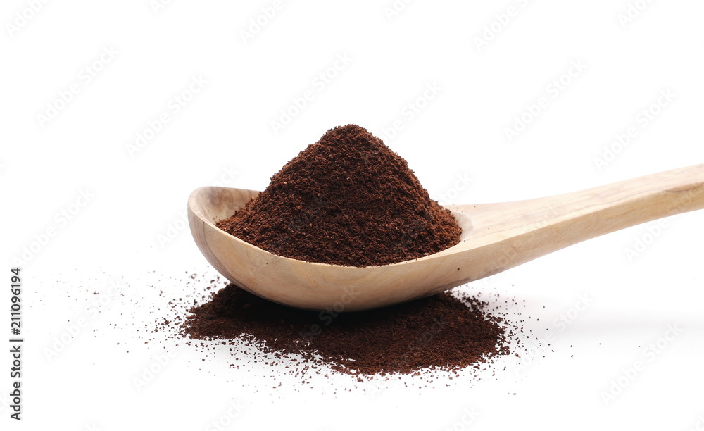 Pile of powdered, instant coffee with wooden spoon isolated on white background Pile of powdered, instant coffee with wooden spoon isolated on white background