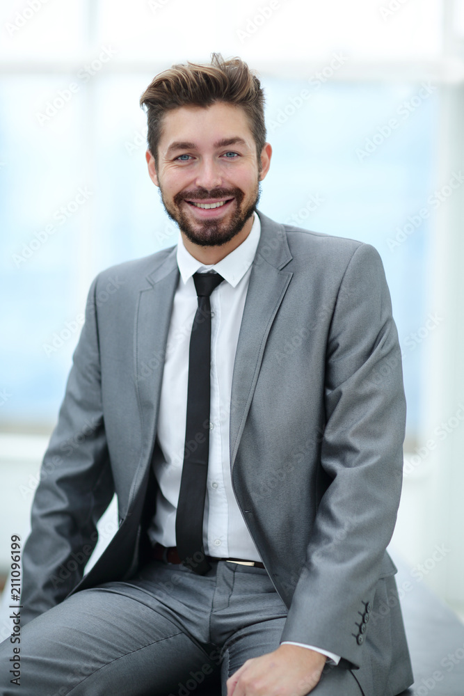 Portrait of a young businessman at the railing in the office Portrait of a young businessman at the railing in the office