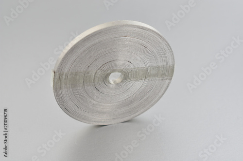 Magnesium ribbon stock images. Laboratory accessories. Laboratory equipment on a silver background. A coil of magnesium ribbon. Chemical element