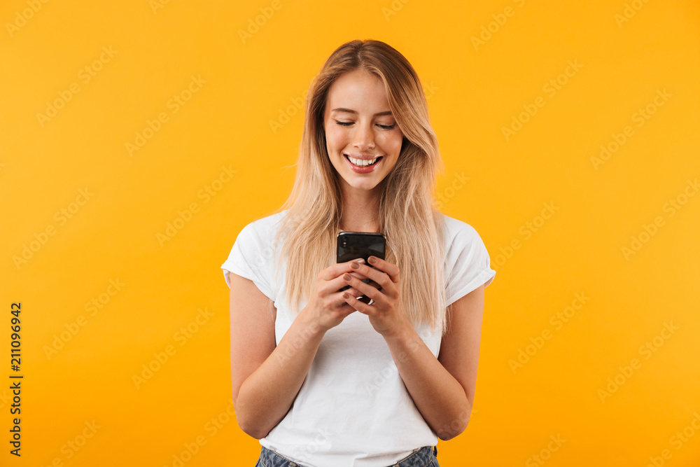 Portrait of a smiling young blonde girl using mobile phone Portrait of a smiling young blonde girl using mobile phone
