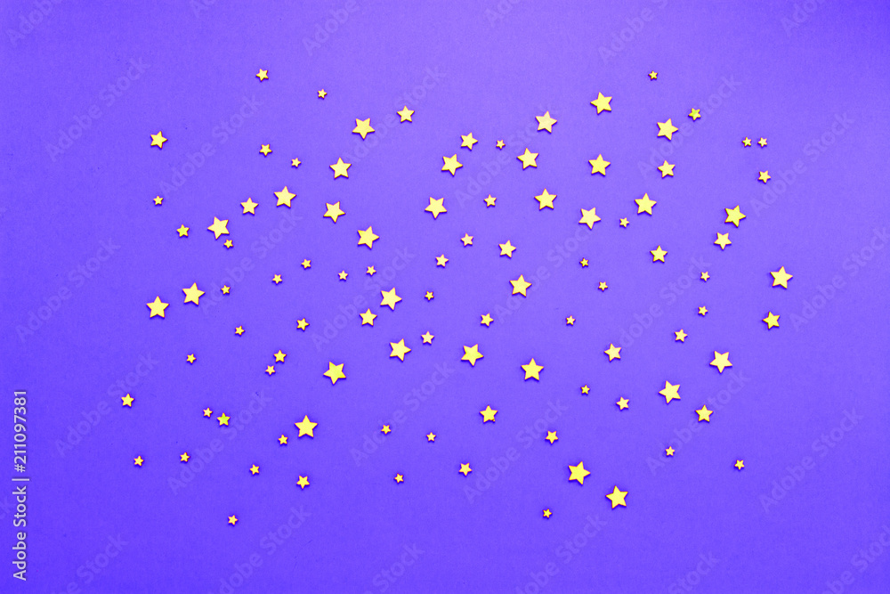 Decorative stars on a lilac background. Concept of the night sky. Can be used as wallpaper or background. Flat lay, top view Decorative stars on a lilac background. Concept of the night sky. Can be used as wallpaper or background. Flat lay, top view