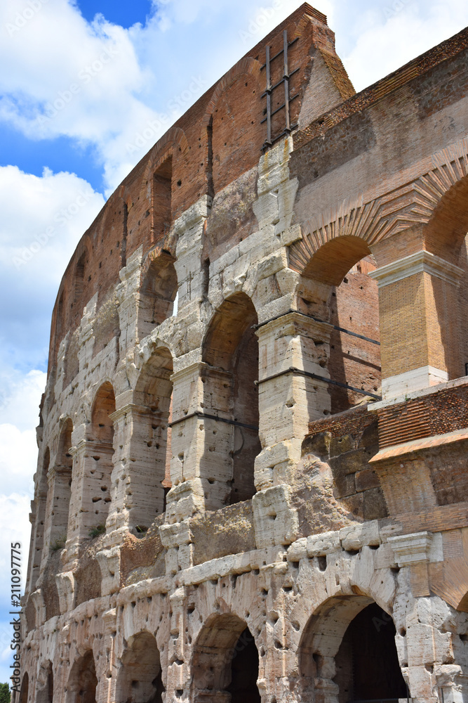 Italy,  Colosseum. View of internal and external architectures. Known as the Flavian Amphitheater, it is the largest amphitheater in the world, located in the city center of Rome.