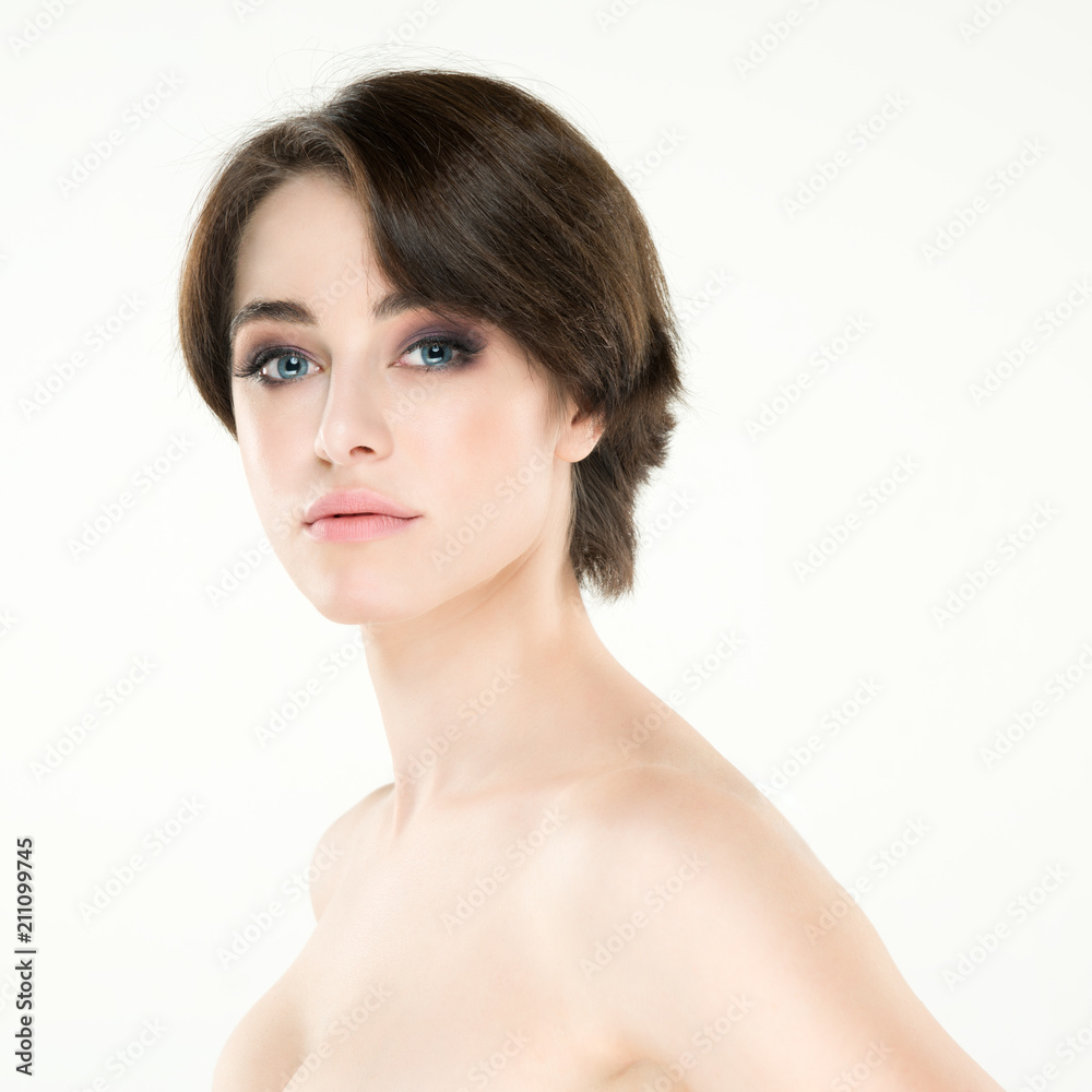 Beauty female portrait. Young attractive woman posing at studio over white background. Beautiful girl. Model with perfect make-up Beauty female portrait. Young attractive woman posing at studio over white background. Beautiful girl. Model with perfect make-up
