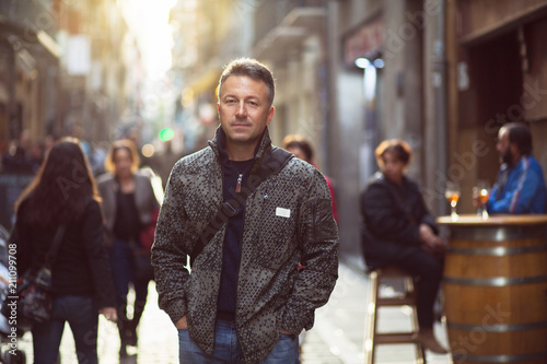 Cuadro en lienzo Handsome middle-aged man walking autumn street